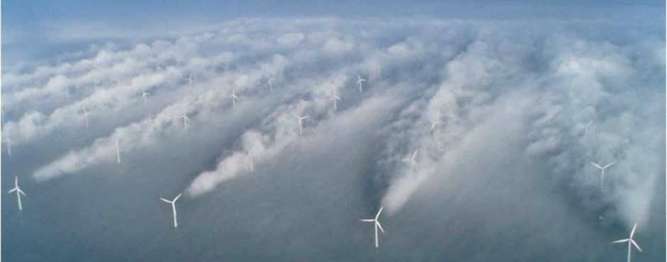 This photo shows an offshore wind farm and wakes behind the wind turbines